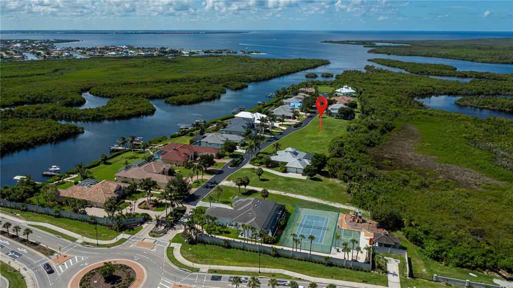 An aerial view shows a residential neighborhood with a vacant lot marked by a pin — 4041 LEA MARIE ISLAND DRIVE, PORT CHARLOTTE, FL