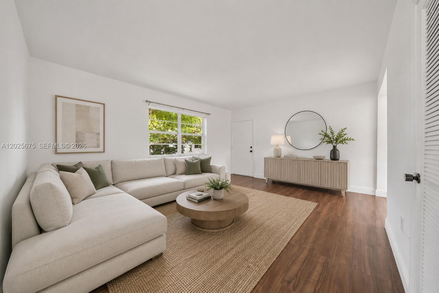 A living room features a beige sectional sofa, a round coffee table, and a wooden sideboard — 5605 SW 80th St # 10D, Miami FL 33143, MIAMI, FL