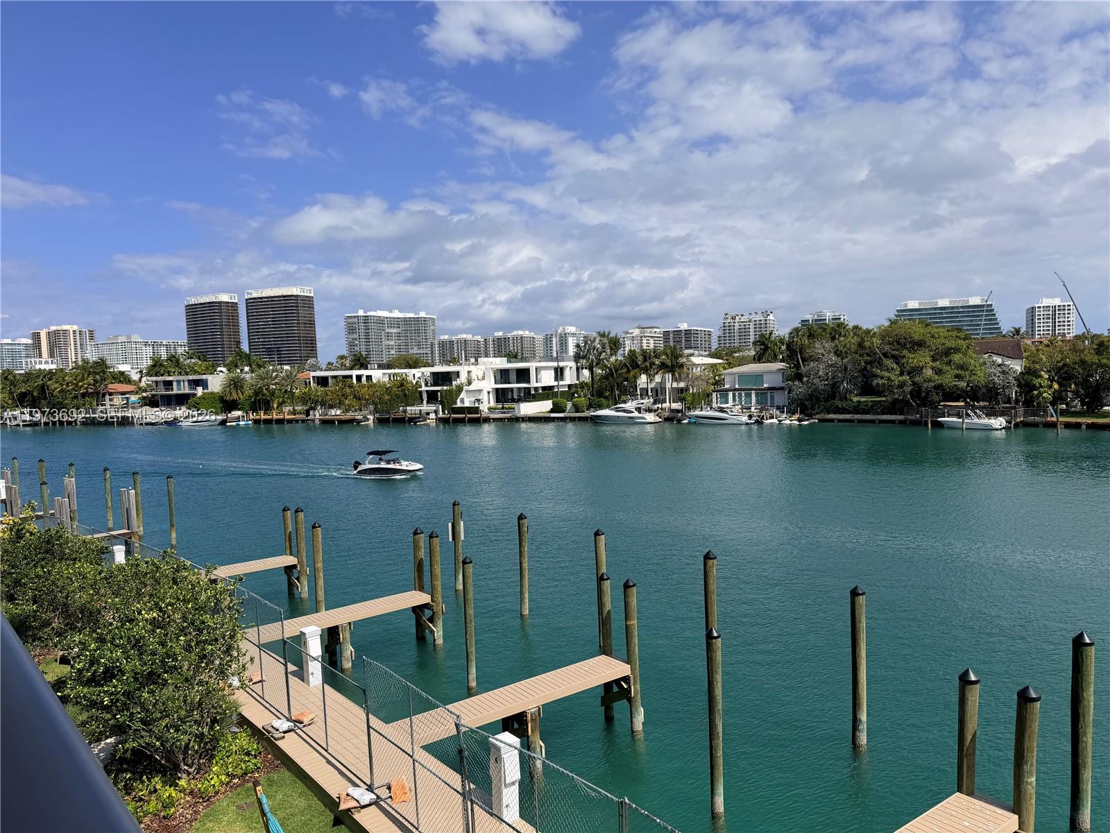 A view of a canal with boat docks and a boat in the water — 9221 E Bay Harbor Dr # 307, Bay Harbor Islands FL 33154, BAY HARBOR ISLANDS, FL