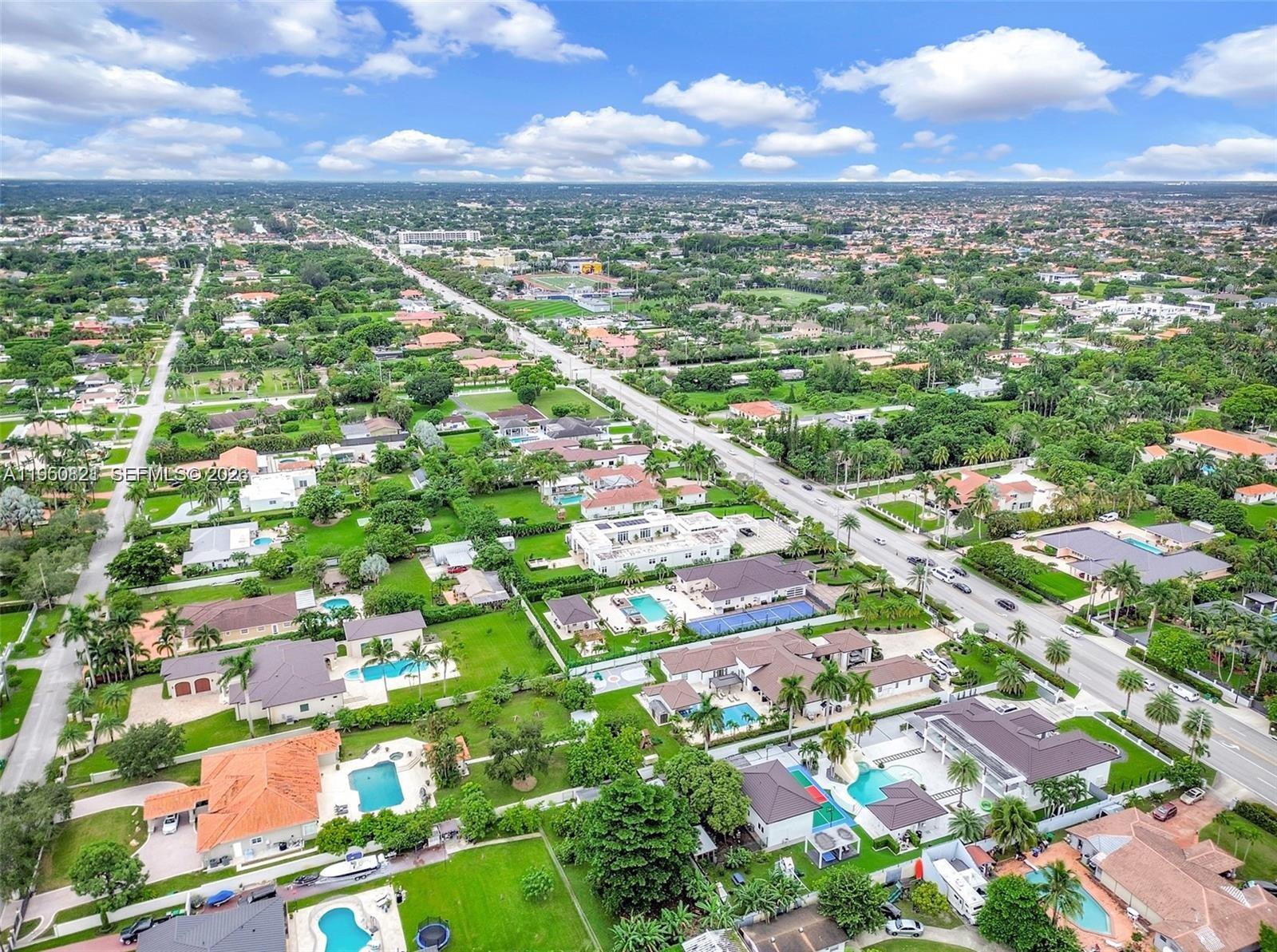 An aerial view shows a suburban neighborhood with many houses featuring private swimming pools — 433 NW 127th Ave, Miami FL 33182, MIAMI, FL