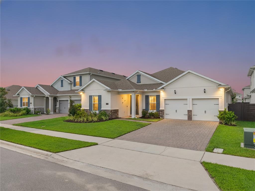 A two-story suburban house with a paved driveway, two-car garage, and a landscaped front yard — 19053 BLUELEAF STREET, ORLANDO, FL