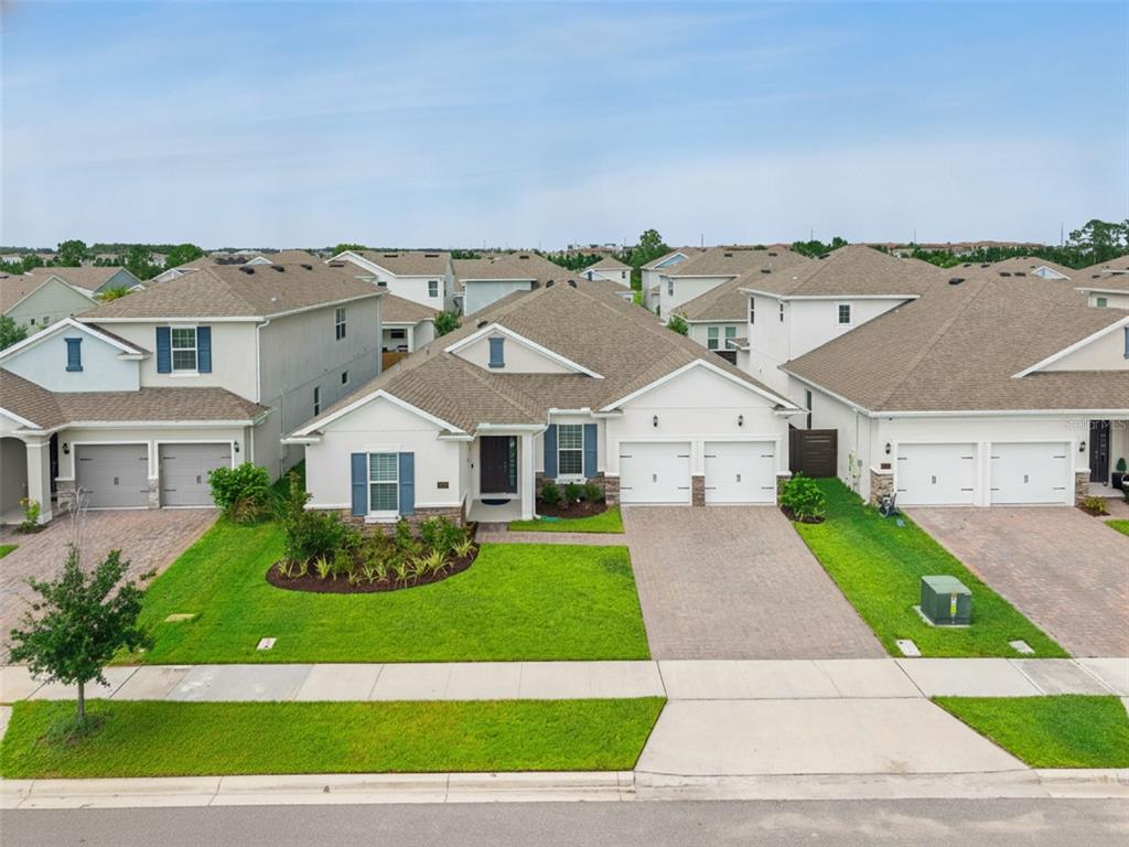 An aerial view of a suburban single-story house with a paved driveway and green lawn — 19053 BLUELEAF STREET, ORLANDO, FL