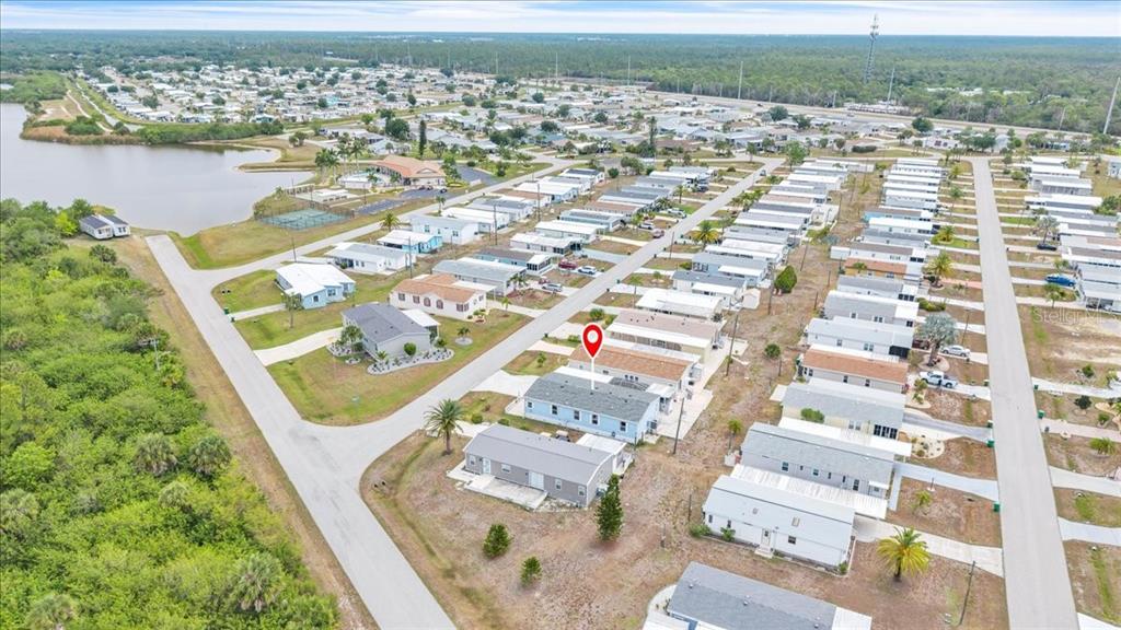 An aerial view shows a light blue manufactured home marked with a red location pin — 3650 ROSSMERE ROAD, PORT CHARLOTTE, FL