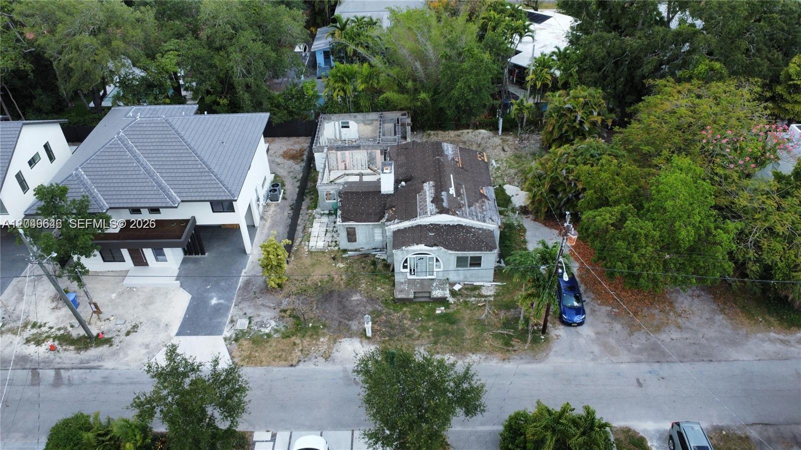 An aerial view shows a dilapidated house under renovation next to a modern two-story home — 751 NE 70th St, Miami FL 33138, MIAMI, FL