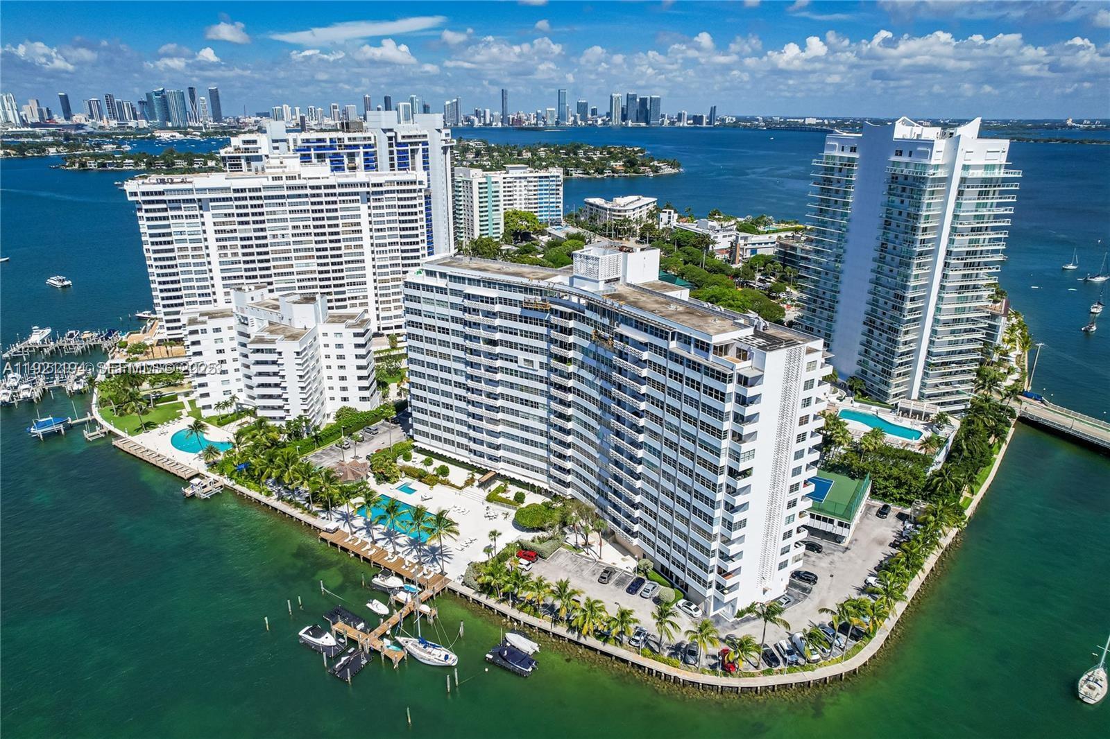 Aerial view of high-rise apartment buildings on a waterfront peninsula with pools and boat docks — 20 E Island Ave # 1415, Miami Beach FL 33139, MIAMI BEACH, FL