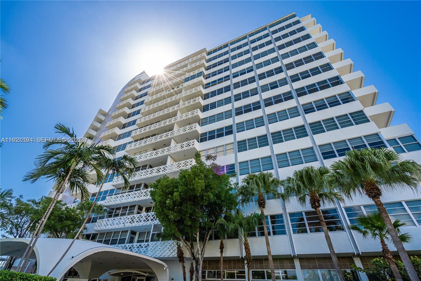 A low-angle view shows the exterior facade of a multi-story residential building with balconies — 20 E Island Ave # 1415, Miami Beach FL 33139, MIAMI BEACH, FL