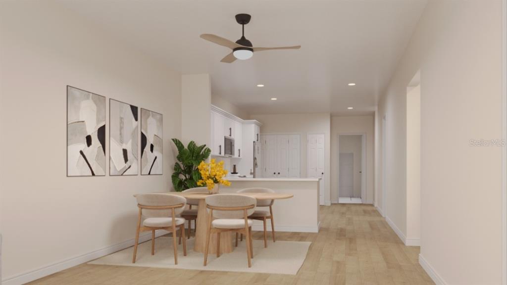 This rendering shows a dining area with a round table and chairs near a kitchen — 1411 OAK PL UNIT B, APOPKA, FL