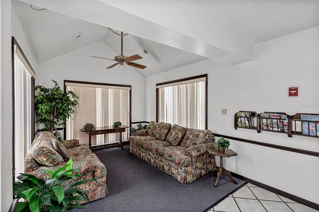 A waiting room features two floral sofas, a ceiling fan, and wall-mounted magazine racks — 131 W MAIN STREET, TAVARES, FL