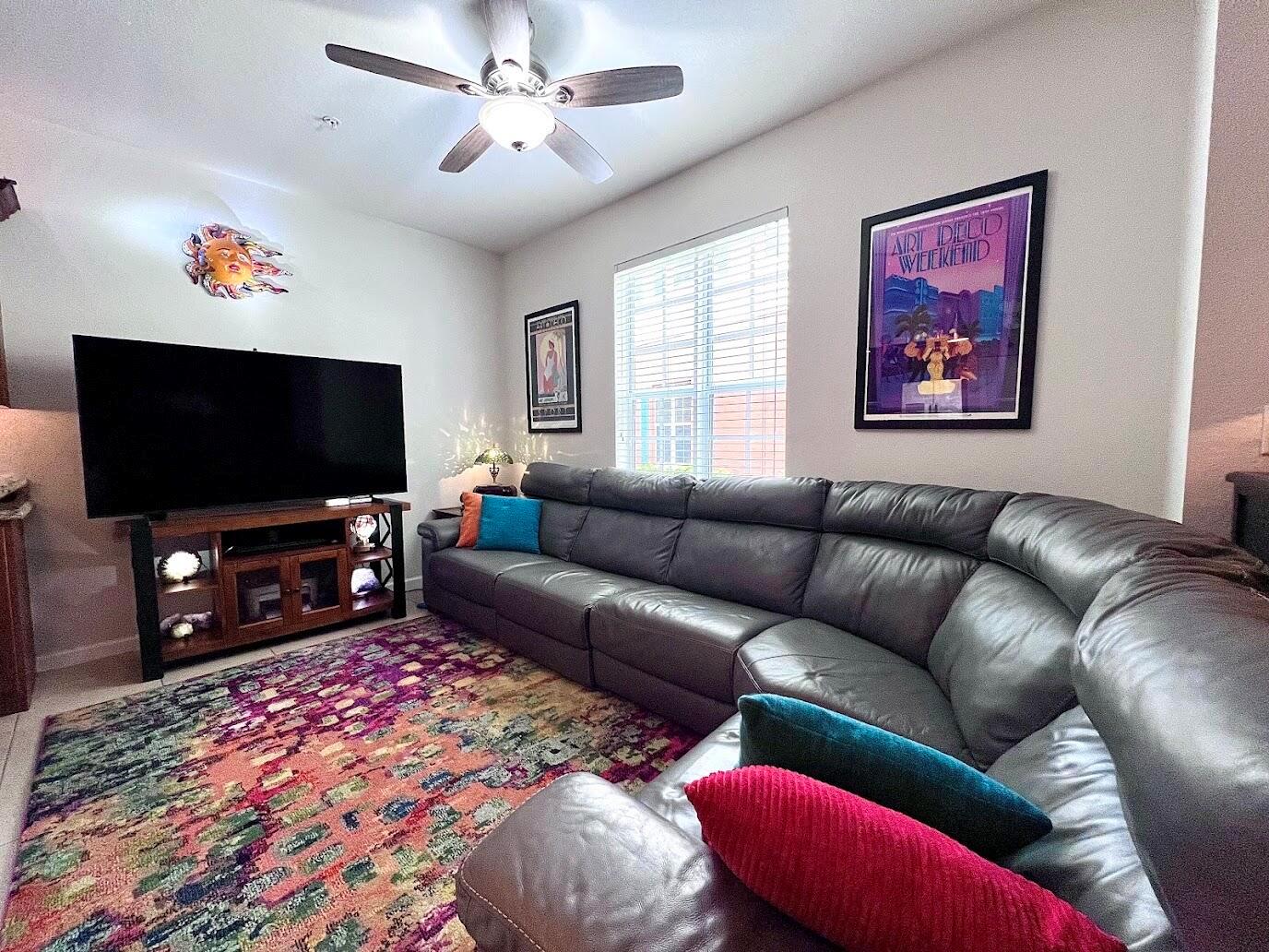 A living room features a large grey sectional sofa, a television, and a colorful rug — 726 SW 1st Way, Pompano Beach FL 33060, POMPANO BEACH, FL