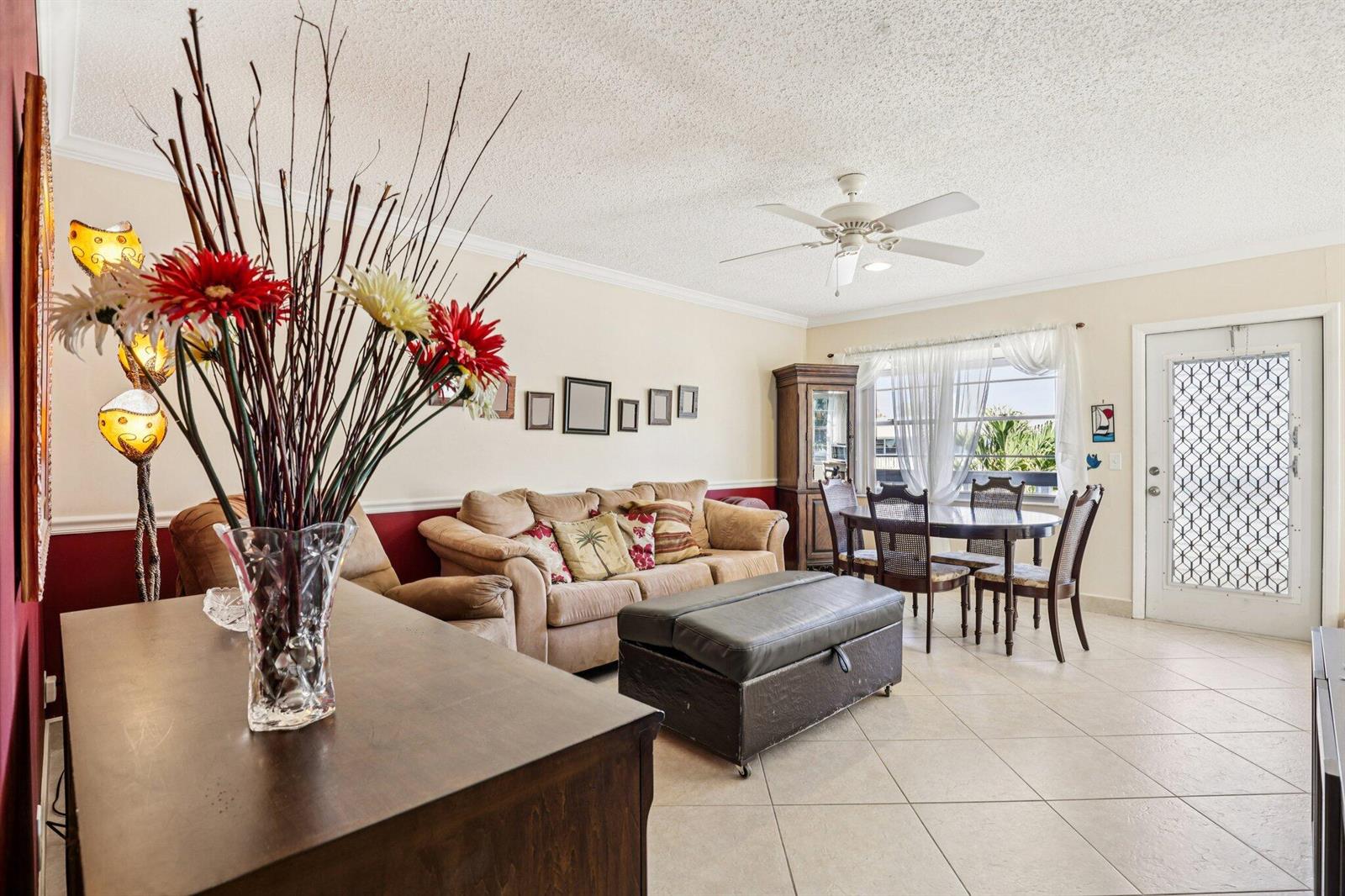 A living and dining area features tile floors, a ceiling fan, and a beige sofa — 104 Oakridge # H, Deerfield Beach FL 33442, DEERFIELD BEACH, FL