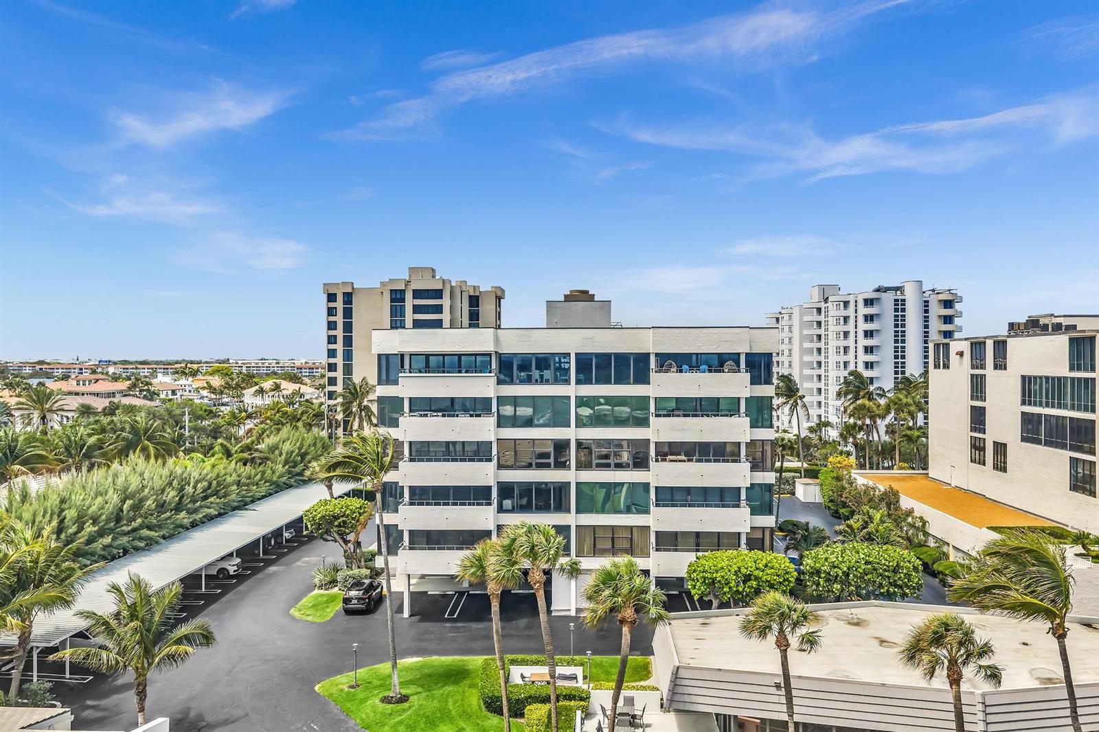 An exterior view of a multi-story apartment building with balconies and a parking lot — 2175 S Ocean Boulevard # 305, Delray Beach FL 33483, DELRAY BEACH, FL