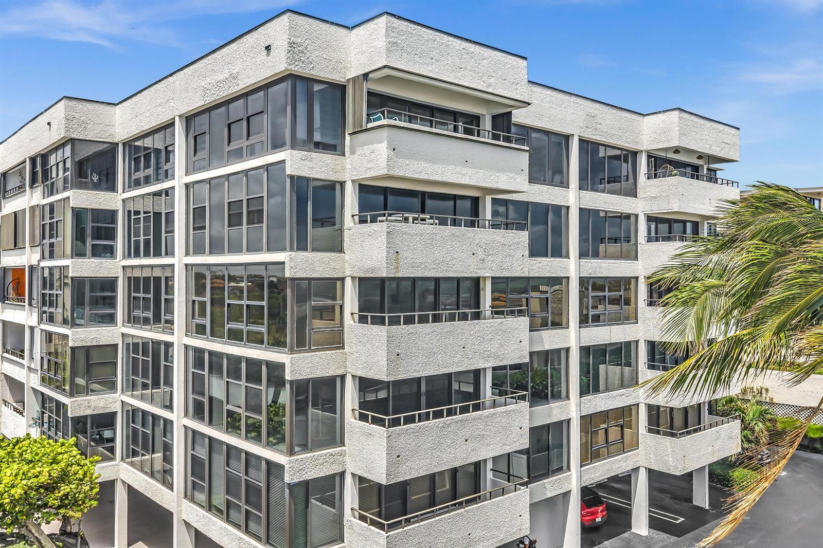 A multi-story apartment building with white stucco walls, glass-enclosed balconies, and large windows — 2175 S Ocean Boulevard # 305, Delray Beach FL 33483, DELRAY BEACH, FL