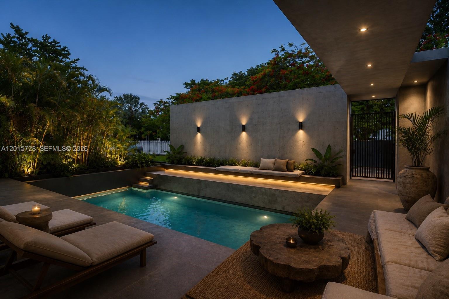 A modern outdoor patio features a swimming pool, concrete walls, lounge seating, and ambient lighting — 221 SW 25th Rd, Miami FL 33129, MIAMI, FL