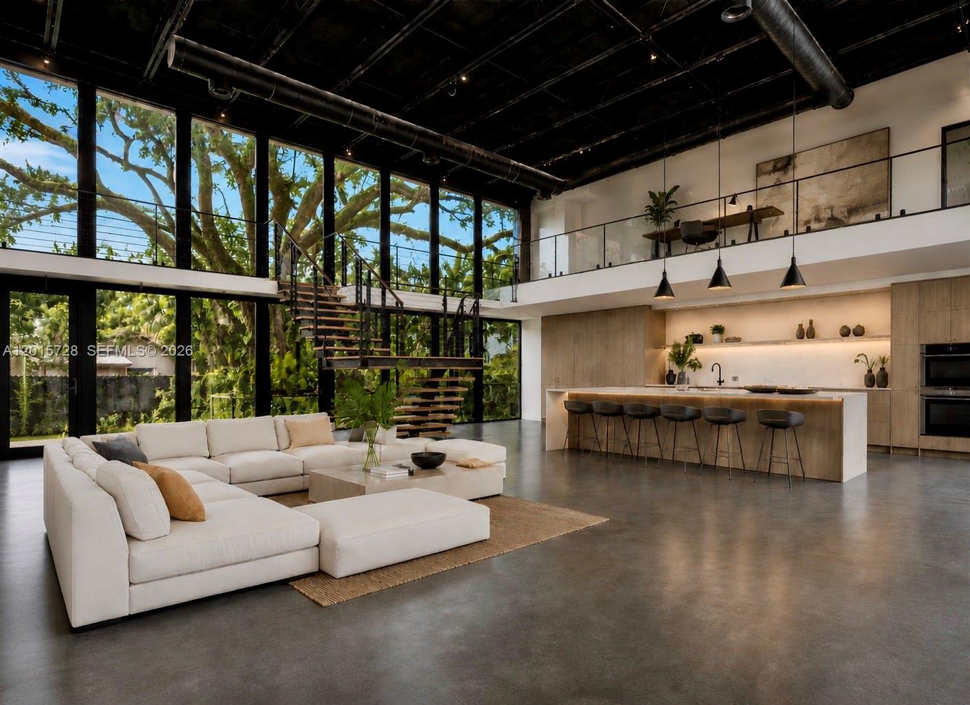 A modern open-concept living area features a large sectional sofa, kitchen island, and floor-to-ceiling windows — 221 SW 25th Rd, Miami FL 33129, MIAMI, FL