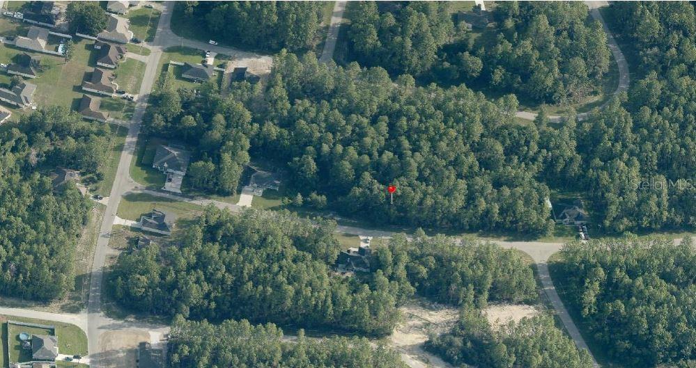 An aerial view shows a wooded, undeveloped residential lot marked with a red pin — Lot 6 SW 138TH ST ROAD, OCALA, FL