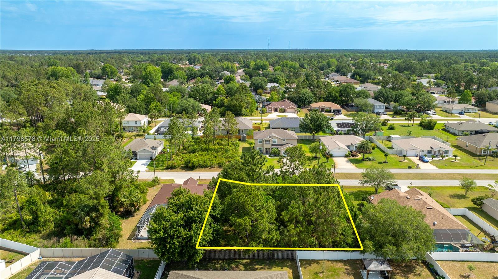 An aerial view shows a vacant, tree-covered residential lot outlined in yellow — 35 Butternut Dr., Palm Coast FL 32137, PALM COAST, FL