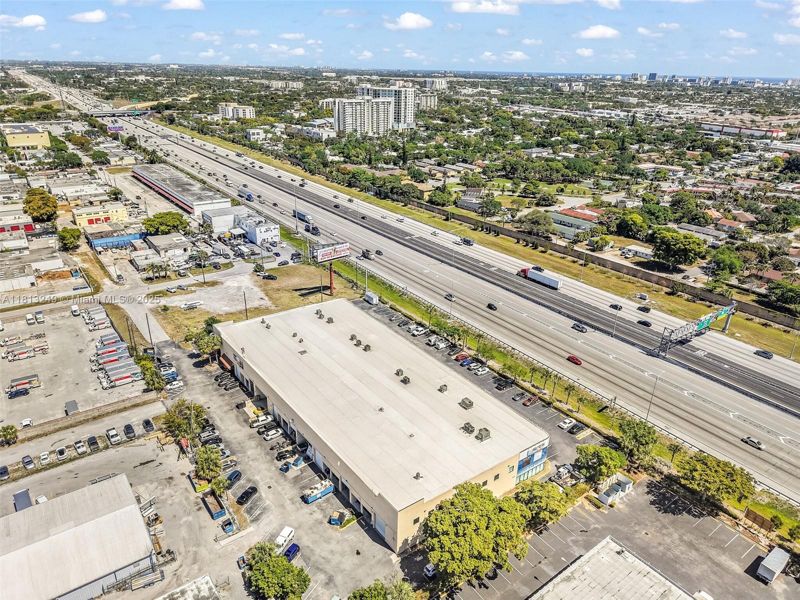An aerial view shows a commercial warehouse building situated next to a multi-lane highway — 820 SW 12th Ave # 7B, Pompano Beach FL 33069, POMPANO BEACH, FL