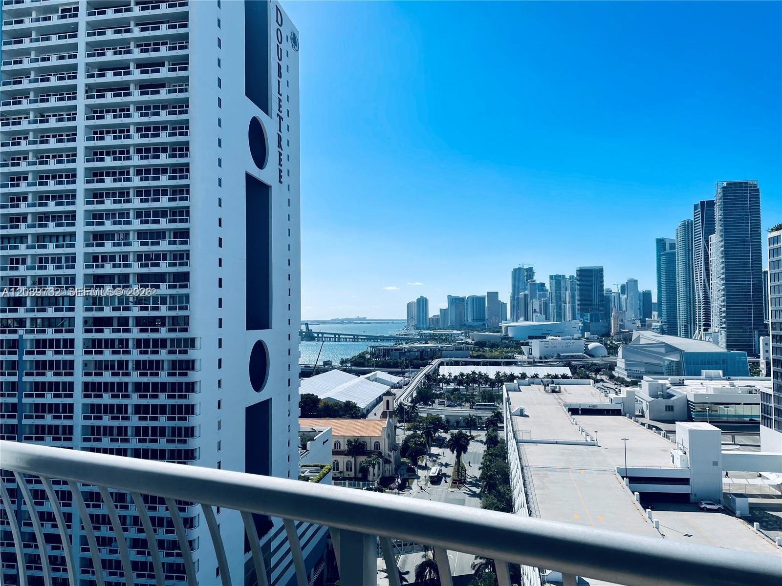 A high-angle view shows a city skyline, a bay, and a nearby hotel building — 1750 N Bayshore Dr # 2112, Miami FL 33132, MIAMI, FL