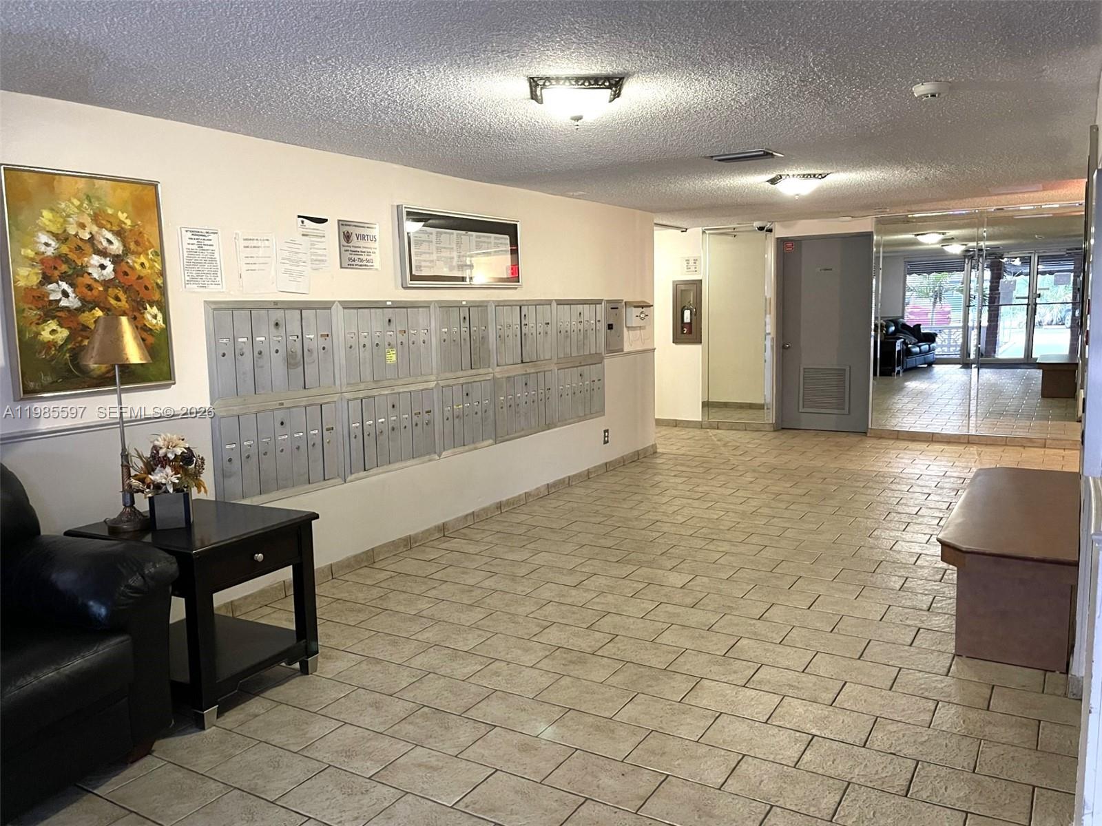 A covered walkway leads to the entrance of a building marked with the number 2061 — 2061 NW 47th Ter # 306, Lauderhill FL 33313, LAUDERHILL, FL