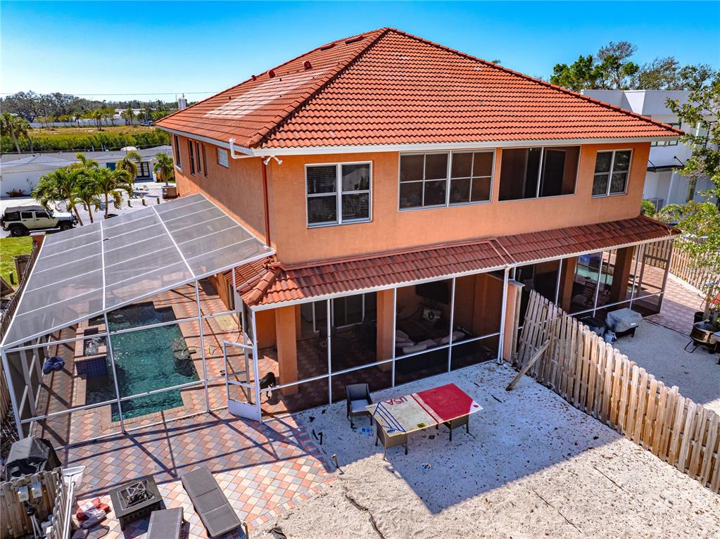 An aerial view shows a two-story house with a tiled roof, pool, and screened patio — 2119 & 2125 MONTCLAIR DRIVE UNIT 1 & 2, SARASOTA, FL