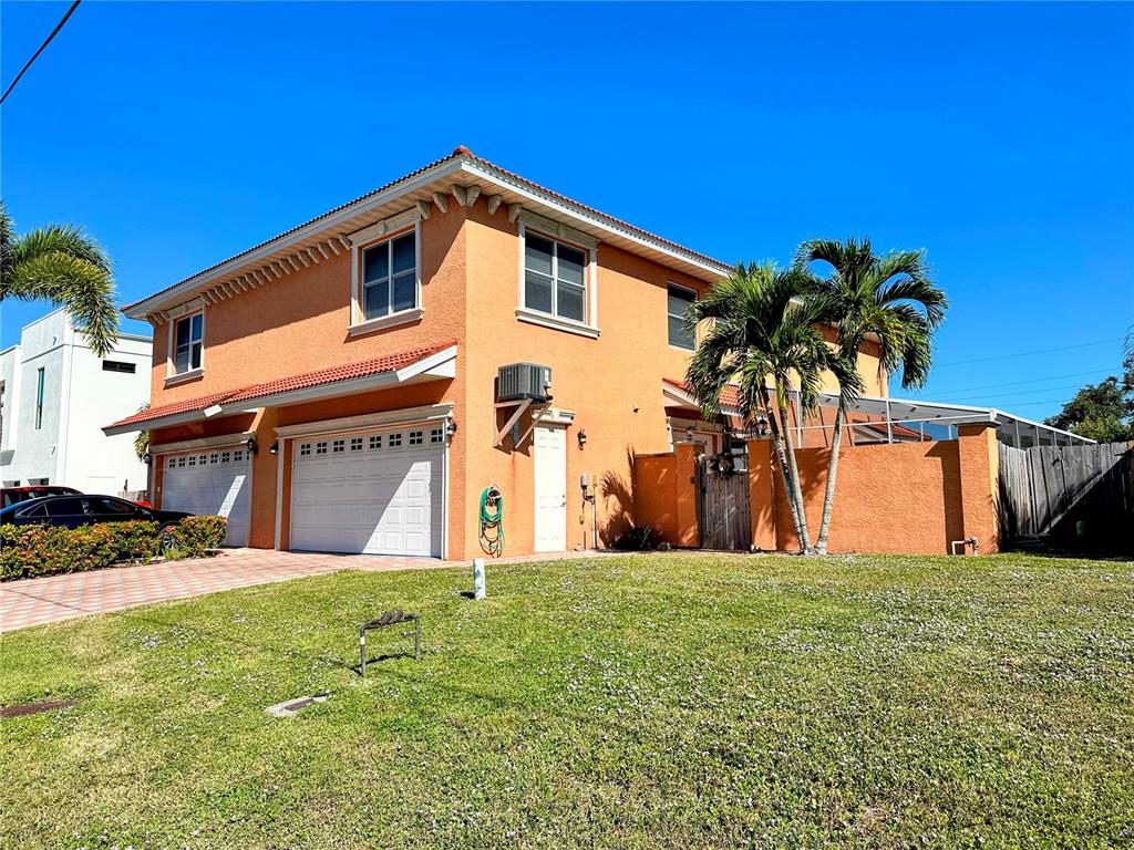 A two-story orange stucco house features a two-car garage and palm trees on the lawn — 2119 & 2125 MONTCLAIR DRIVE UNIT 1 & 2, SARASOTA, FL