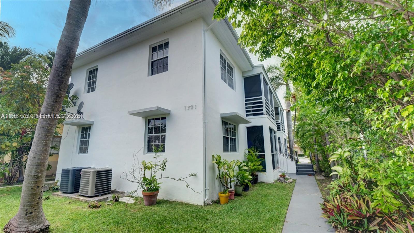 A two-story white building with a sidewalk, landscaping, and two outdoor air conditioning units — 1791 Marseille Dr, Miami Beach FL 33141, MIAMI BEACH, FL