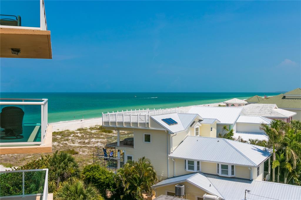 An elevated view of a beach house with a white roof overlooking the ocean — 880 MANDALAY AVENUE UNIT N412, CLEARWATER, FL