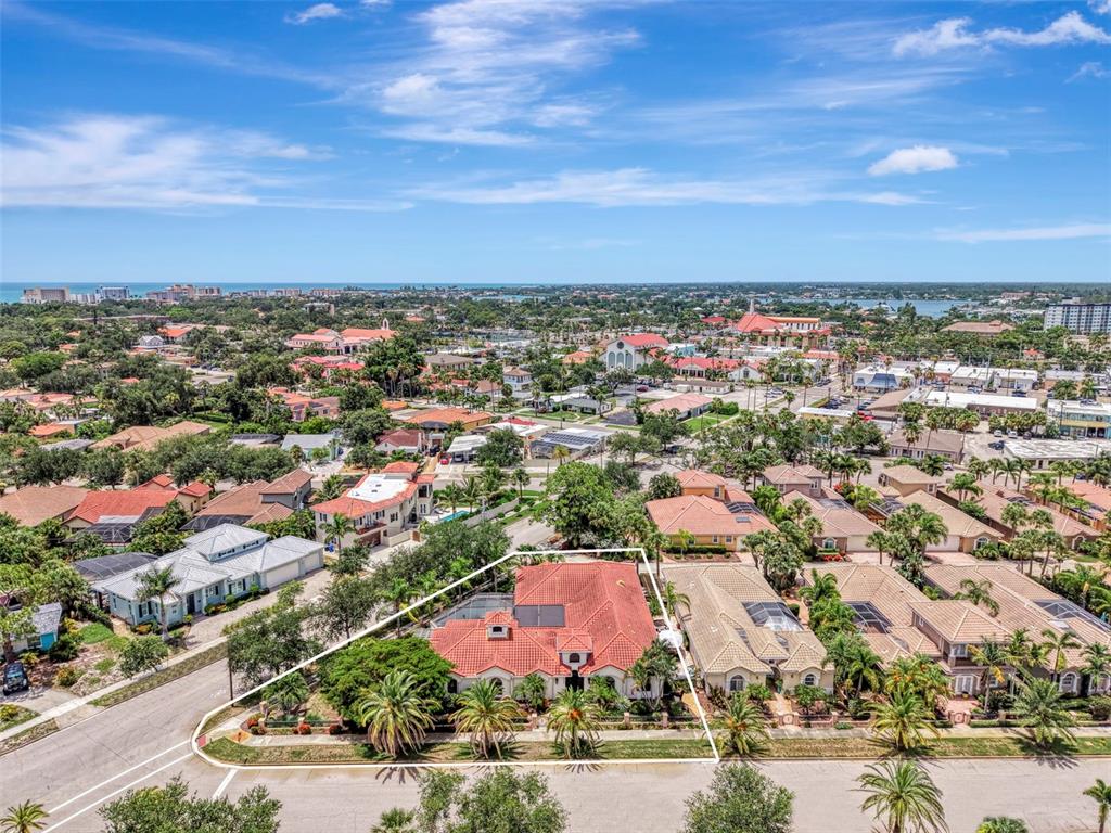 An aerial view shows a single-story house with a red tile roof and pool — 256 PENSACOLA ROAD, VENICE, FL