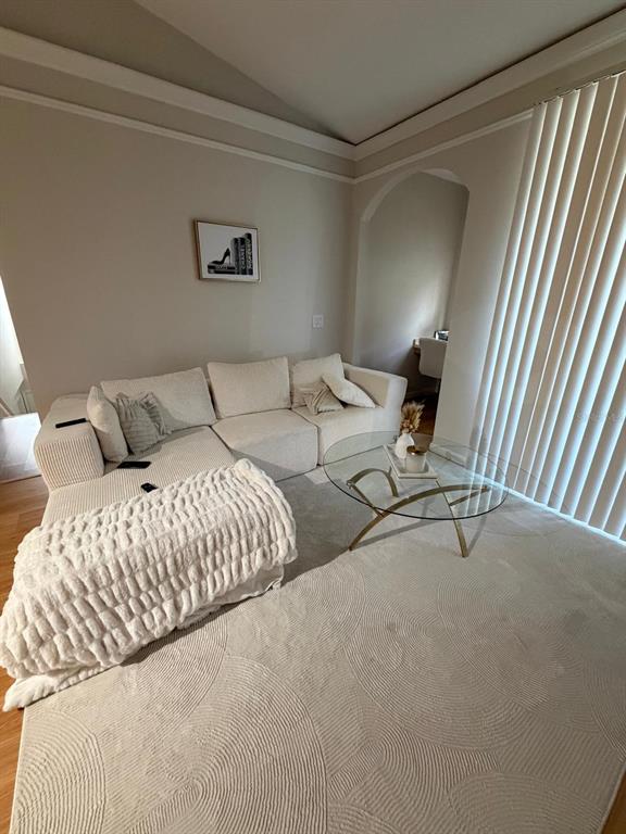 A living room features a white sectional sofa, a glass coffee table, and a textured rug — 12024 VILLANOVA DRIVE UNIT 105, ORLANDO, FL