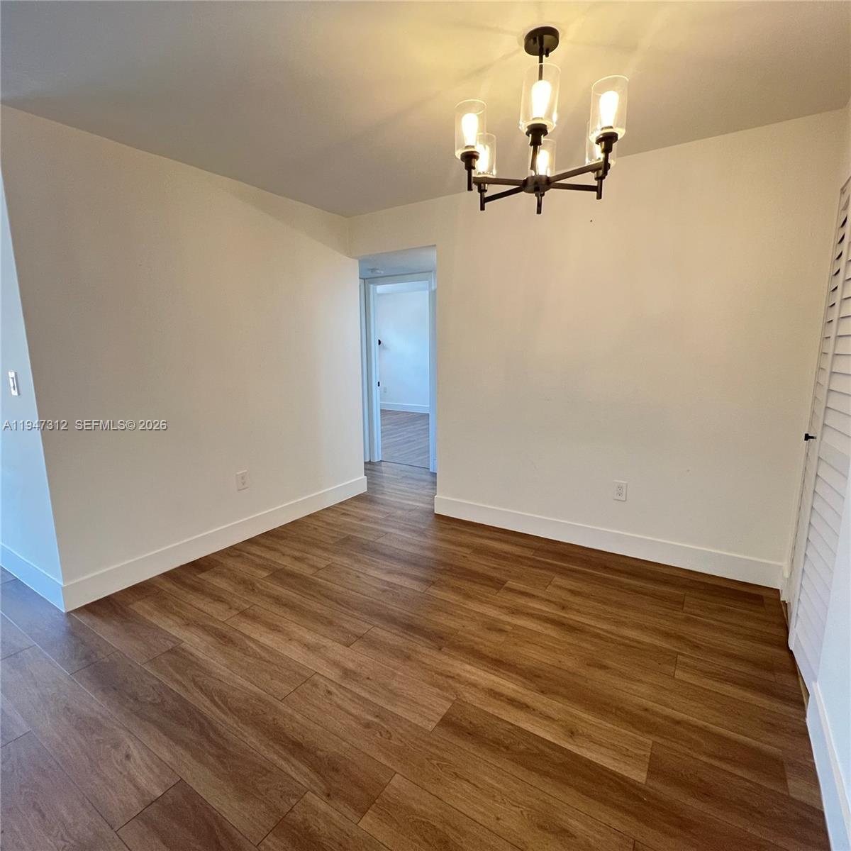 A kitchen features white flat-panel cabinets, stainless steel appliances, and light speckled countertops — 8425 NW 8th St # 406, Miami FL 33126, MIAMI, FL