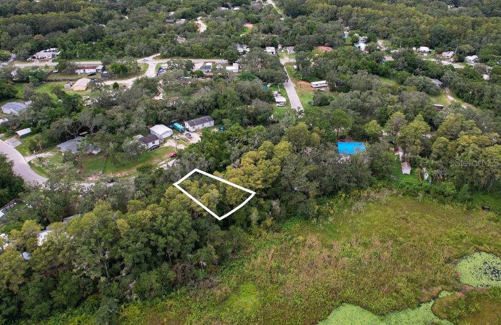 An aerial view shows a wooded lot outlined in white next to a marshy area — 36 POPLAR STREET, NEW PORT RICHEY, FL