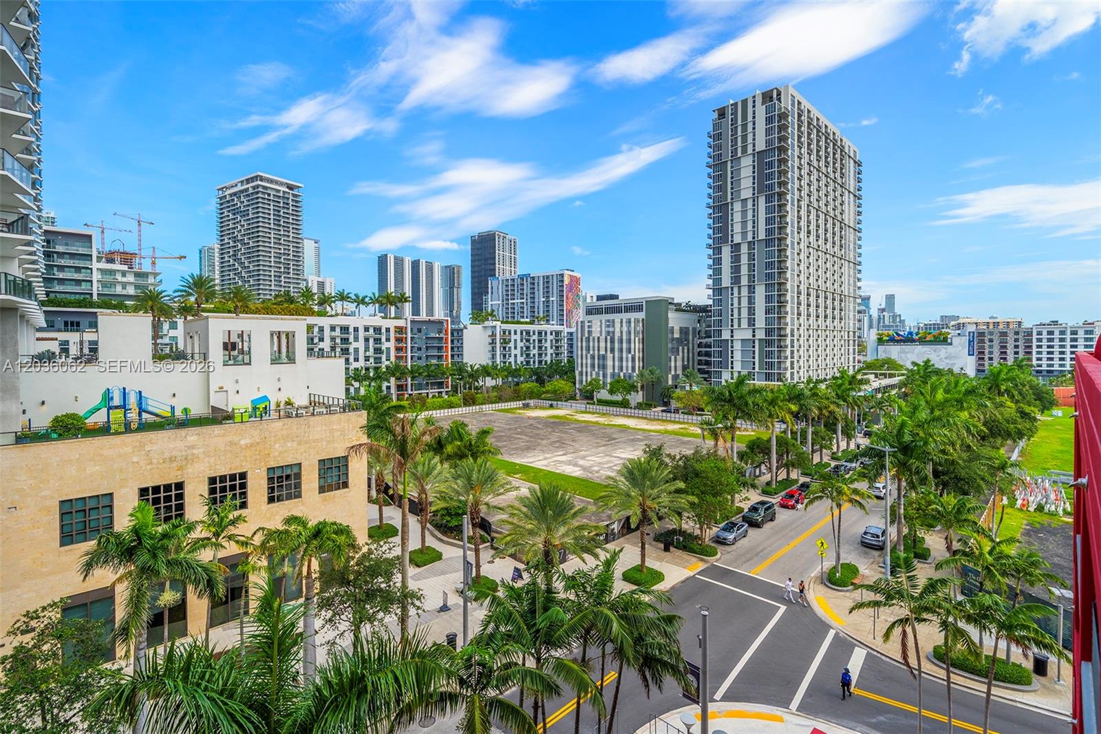 An elevated view shows a city street intersection with palm trees and surrounding high-rise buildings — MIAMI, FL
