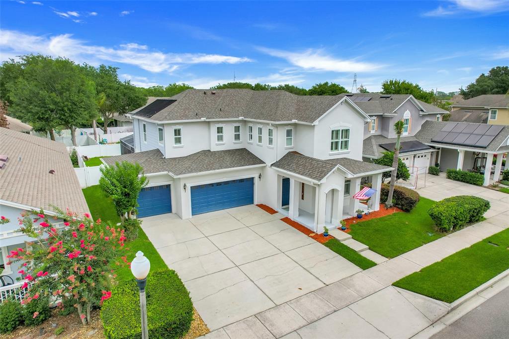 An aerial view of a two-story suburban house with a blue garage and gray roof — 7242 LONDALE BOULEVARD, WINDERMERE, FL
