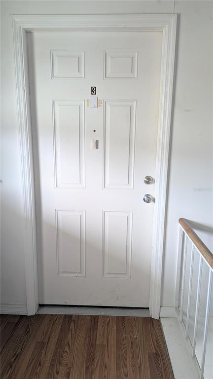 A white six-panel door with the number three is positioned at the top of stairs — 4158 TAMIAMI TRAIL UNIT U3, PORT CHARLOTTE, FL
