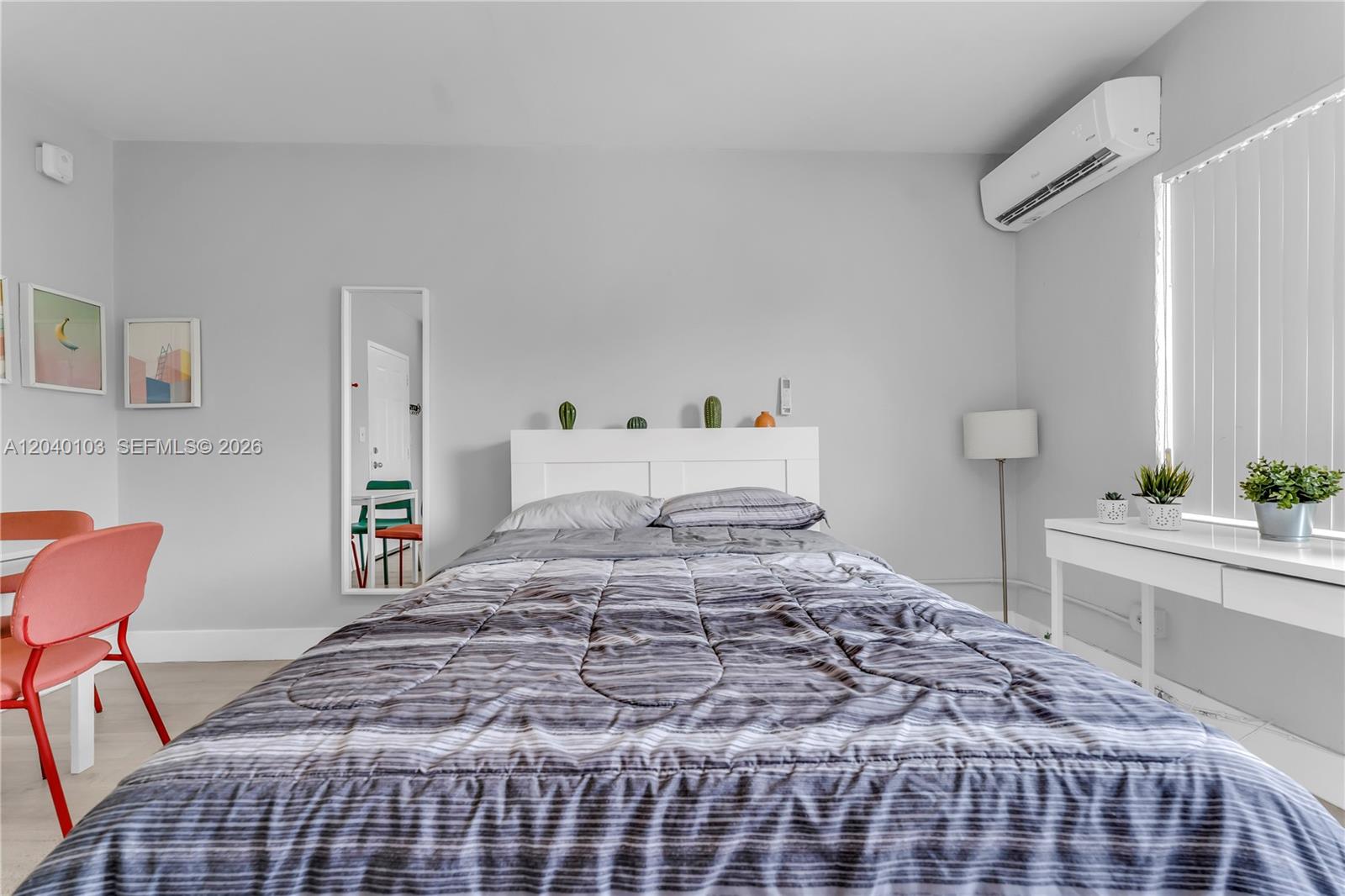 A bedroom features a bed with a gray patterned comforter, a white headboard, and a desk — 6647 SW 59th Pl # 208, South Miami FL 33143, SOUTH MIAMI, FL