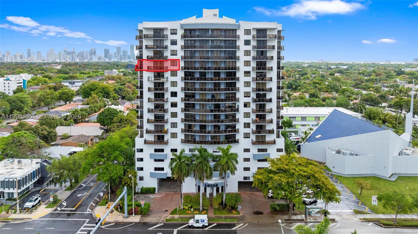 An exterior view of a high-rise residential building with a red box highlighting a balcony — 2301 SW 27th Ave # 906, Miami FL 33145, MIAMI, FL