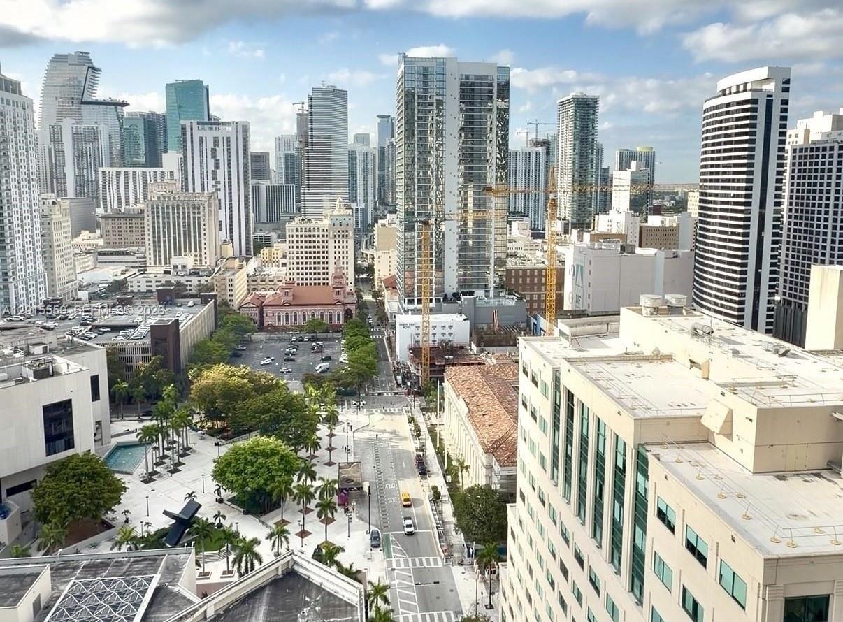 High-angle view of a dense urban skyline with numerous skyscrapers, a park, and city streets — 121 NE 5th St # 2705, Miami FL 33132, MIAMI, FL