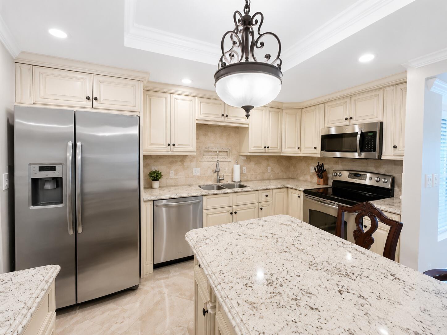 A living and dining area with marble floors, ornate wooden furniture, and a balcony view — 1370 S Ocean Boulevard # 603, Pompano Beach FL 33062, POMPANO BEACH, FL