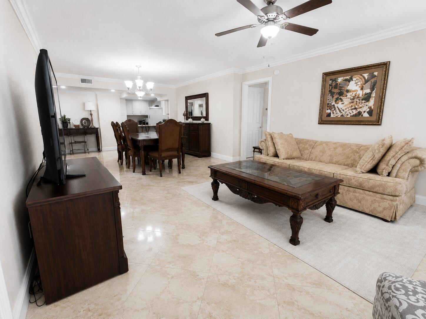 An empty room with beige marble tile floors, a ceiling fan, and large sliding glass doors — 1370 S Ocean Boulevard # 603, Pompano Beach FL 33062, POMPANO BEACH, FL