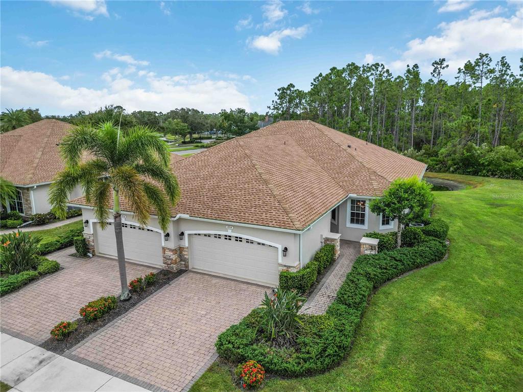 An aerial view of a single-story house with a three-car garage and paved driveway — 1914 SCARLETT AVENUE, NORTH PORT, FL
