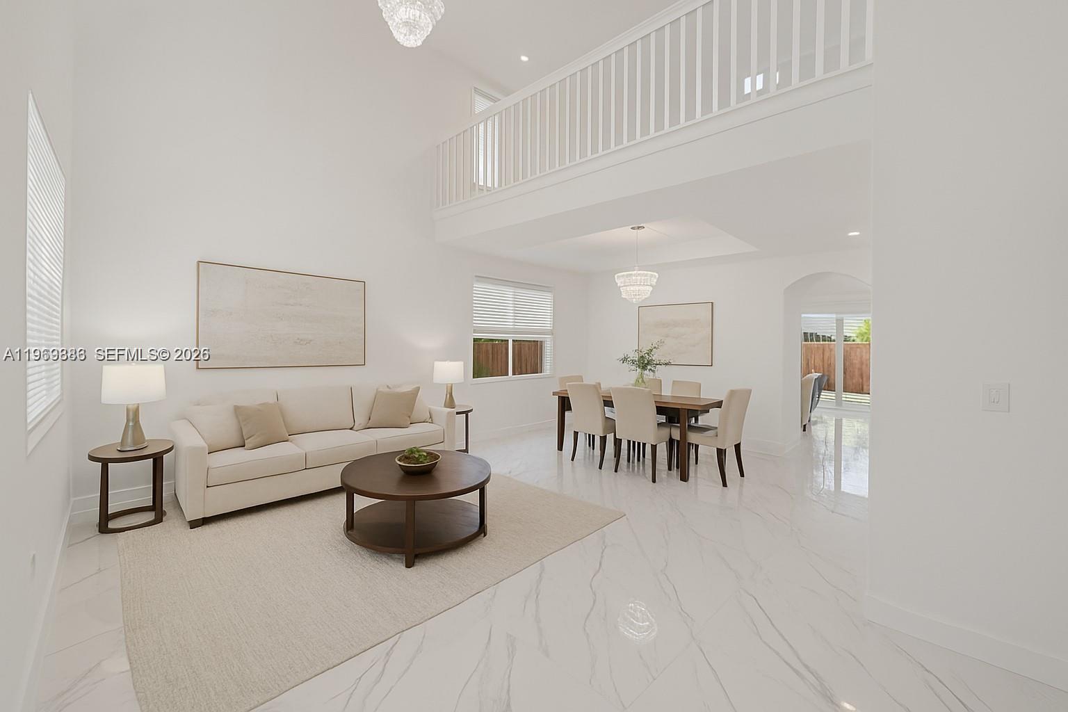 A bright living and dining area features high ceilings, white marble floors, and a balcony — 642 SE 37th PL, Homestead FL 33033, HOMESTEAD, FL