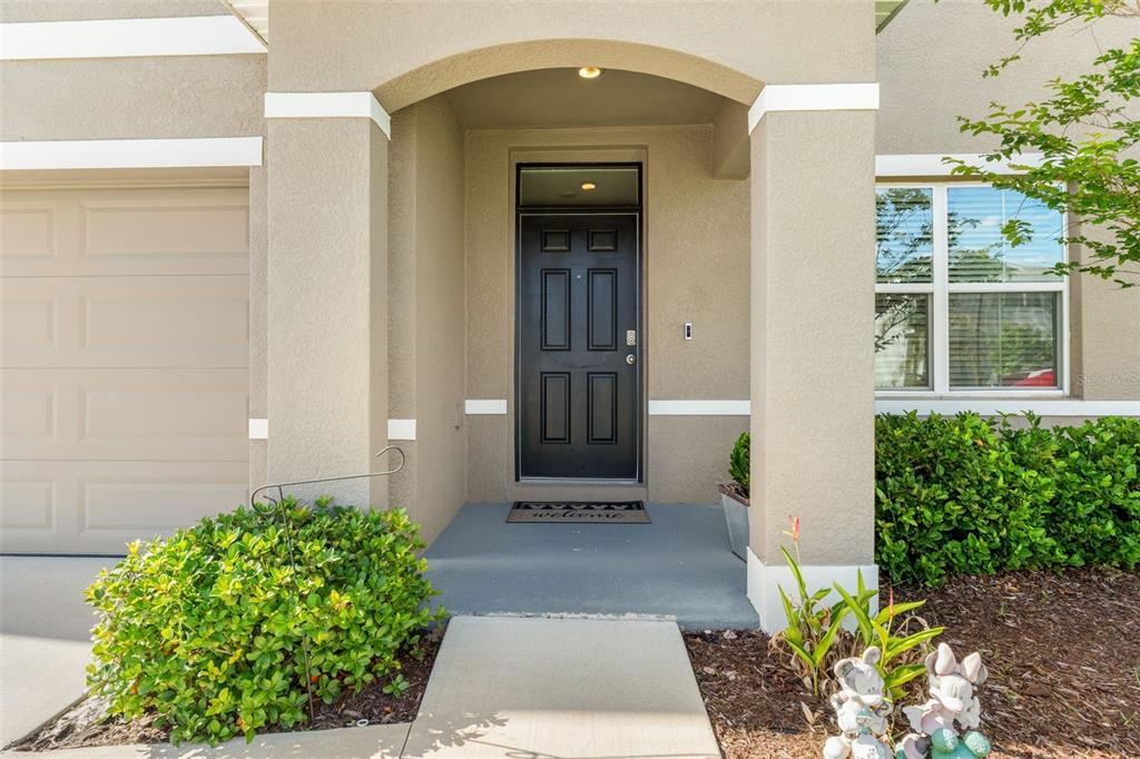 A dining area with a wooden table and hutch sits adjacent to an open kitchen — 33567 HAMILTON HILL LANE, WESLEY CHAPEL, FL