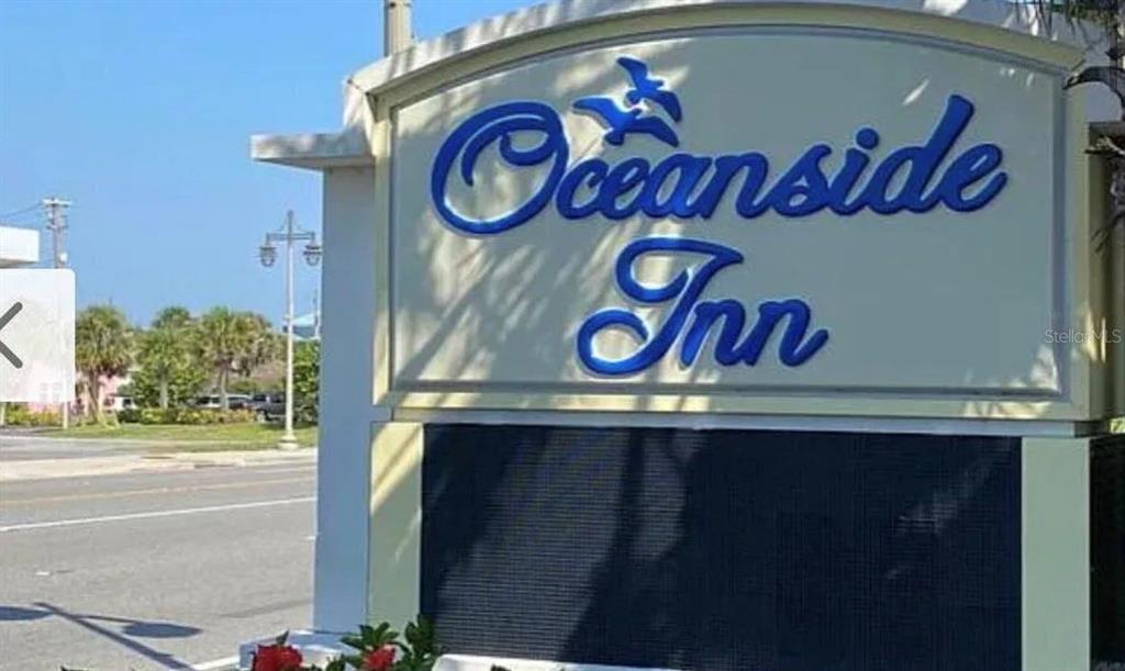 A sign for the Oceanside Inn stands outdoors near a road with palm trees — 1909 S ATLANTIC AVENUE UNIT 411 & 412, DAYTONA BEACH, FL