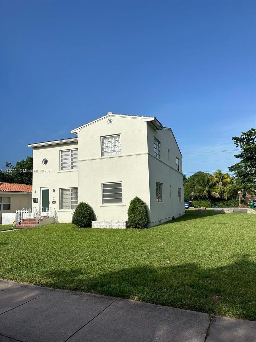 A two-story, light-colored stucco house with a front lawn and glass block windows — 3621 Ponce De Leon Blvd, Coral Gables FL 33134, CORAL GABLES, FL