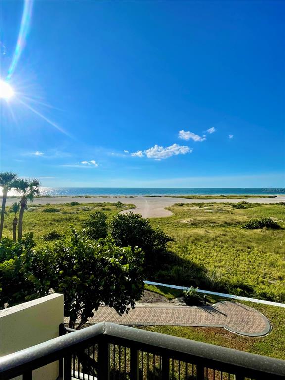 A view from a balcony overlooking a sandy beach, dunes, and the ocean — 1290 GULF BOULEVARD UNIT 307, CLEARWATER, FL