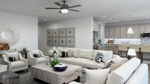 A bright, open-concept living room features a large sectional sofa, two armchairs, and a kitchen — 6 TREE HOUSE PLACE, PALM COAST, FL
