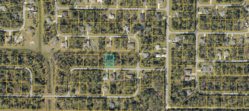 This is an aerial map showing a highlighted vacant lot in a residential neighborhood — GRAVELMANN RD, NORTH PORT, FL