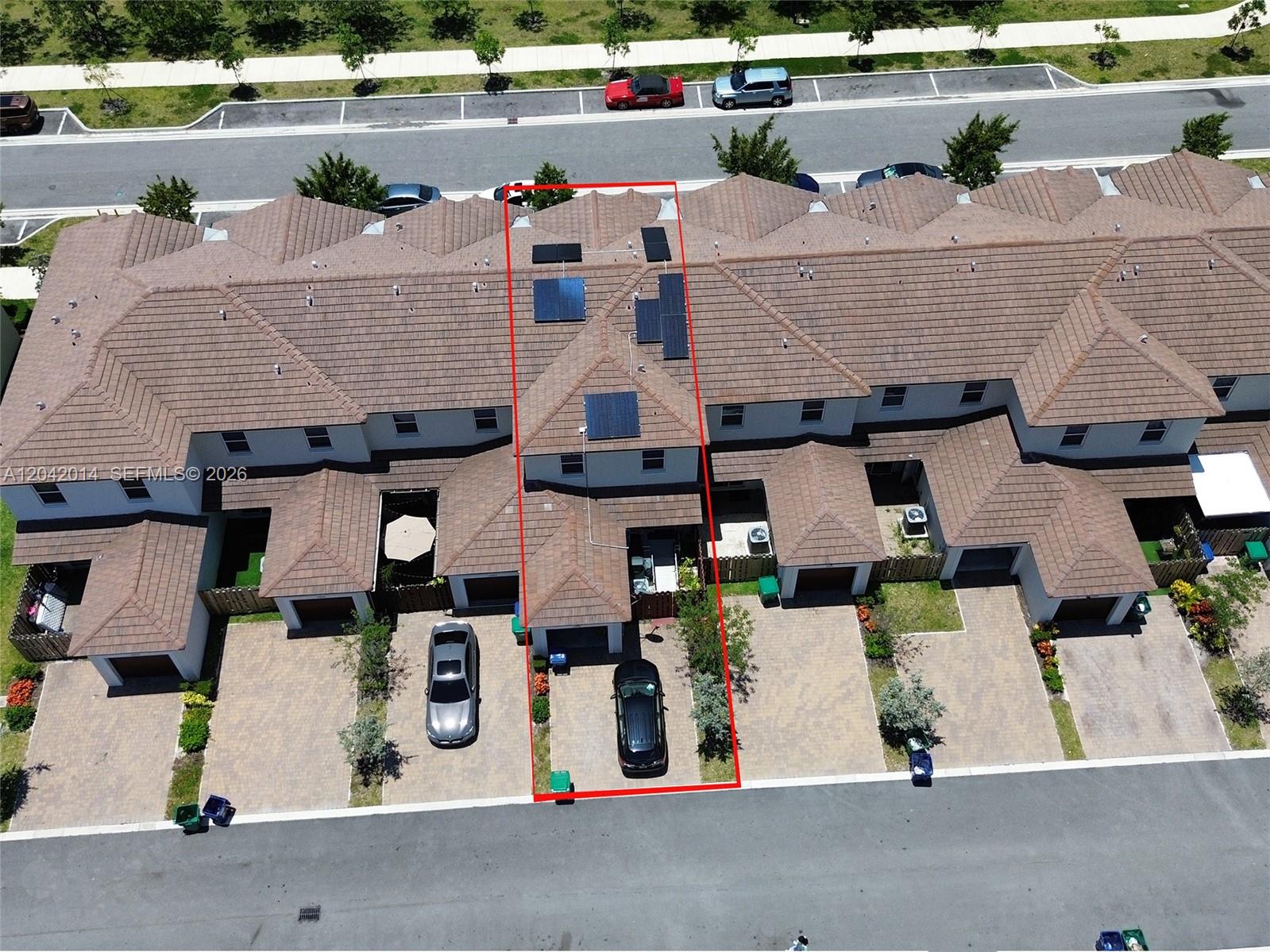 An aerial view shows a townhouse unit with a red outline and rooftop solar panels — 12867 SW 243rd Ter, Homestead FL 33032, HOMESTEAD, FL