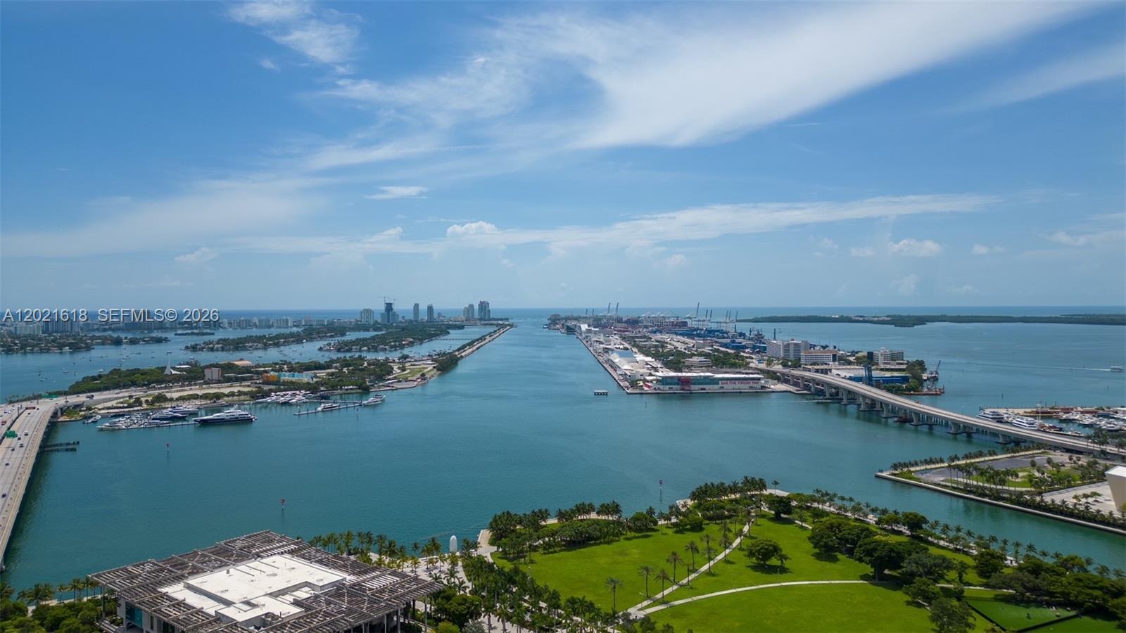 An aerial view shows a waterway separating a park from a cruise port and bridge — 1100 Biscayne Blvd # 2706, Miami FL 33132, MIAMI, FL