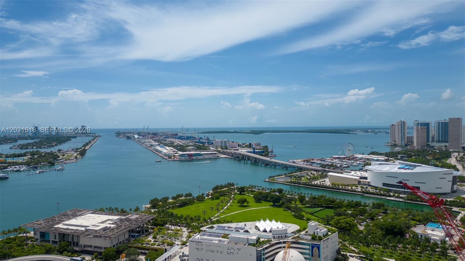 An aerial view shows a waterfront park, a bridge, a stadium, and a harbor — 1100 Biscayne Blvd # 2706, Miami FL 33132, MIAMI, FL